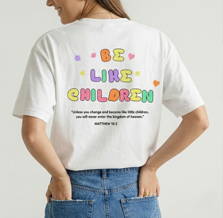 Close-up of the back of white Be Like Children Christian t-shirt showing colorful bubble letter graphic and full Matthew 18:3 Bible verse text