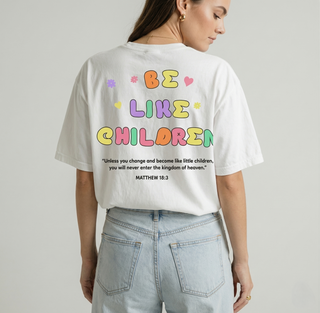Back view close-up of white Be Like Children Christian t-shirt with large colorful bubble letter graphic and Matthew 18:3 Bible verse clearly displayed