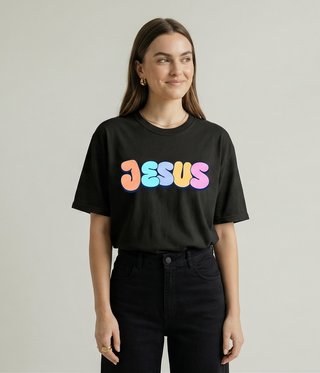 Smiling woman in black Jesus Loves You Christian graphic tee front view - Faith & Co Apparel