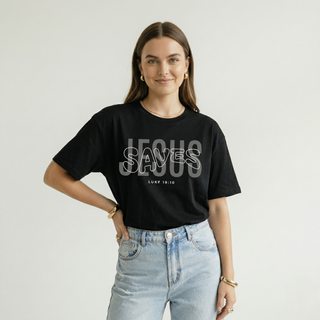 Woman standing with hands on hips in black oversized "Jesus Saves" Luke 19:10 Christian graphic tee with layered bold text design, paired with light jeans