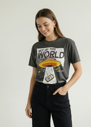 Front close-up view of charcoal "Not of This World" John 17:16 Christian graphic tee with UFO print, styled with black pants